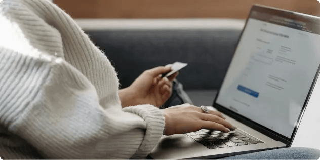 A person sitting down and focused while working on a laptop.