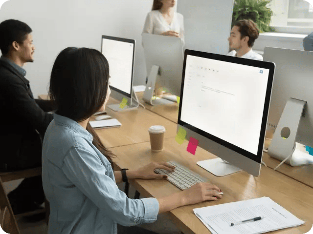 A group of diverse professionals working together in an open office environment.