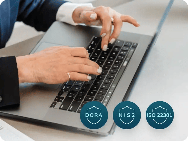 A person using a laptop with a UI snippet in the bottom right corner displaying DORA, NIS2, and ISO 22301 compliance badges.