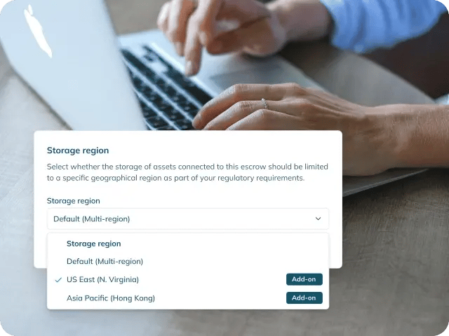 A close-up of a person's hand with a 'Storage Region' selection field UI snippet in the lower-left foreground.