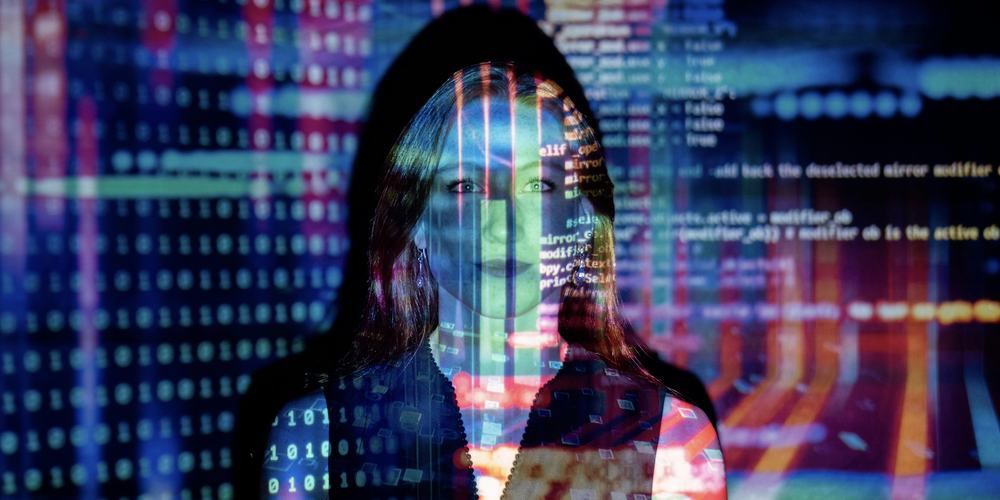 Portrait of a woman with neon lights and code projected onto her face.